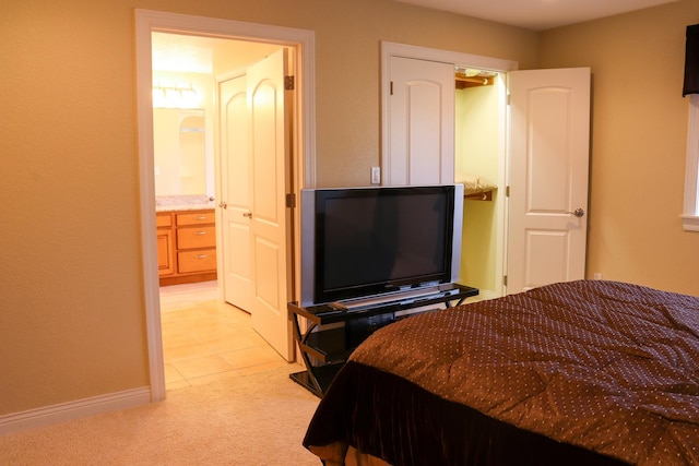 carpeted bedroom featuring ensuite bath