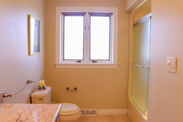 bathroom with tile patterned floors, vanity, toilet, and an enclosed shower