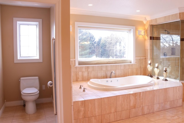 bathroom featuring tile patterned floors, tiled bath, a wealth of natural light, and toilet