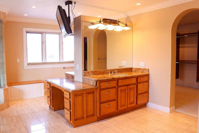 bathroom with tile patterned floors, vanity, ornamental molding, and a tub to relax in