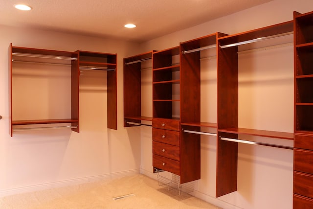 walk in closet with carpet