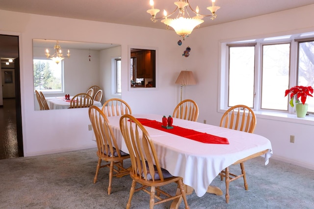 dining space featuring carpet flooring and a notable chandelier