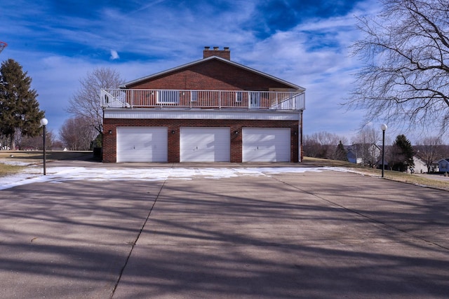 view of home's exterior featuring a balcony and a garage