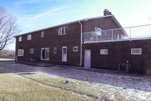 rear view of house featuring a balcony, a patio, and central AC unit