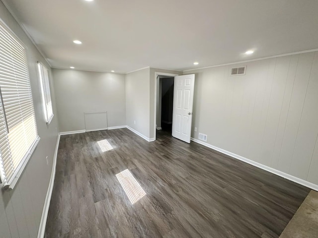 unfurnished room with dark hardwood / wood-style flooring and ornamental molding