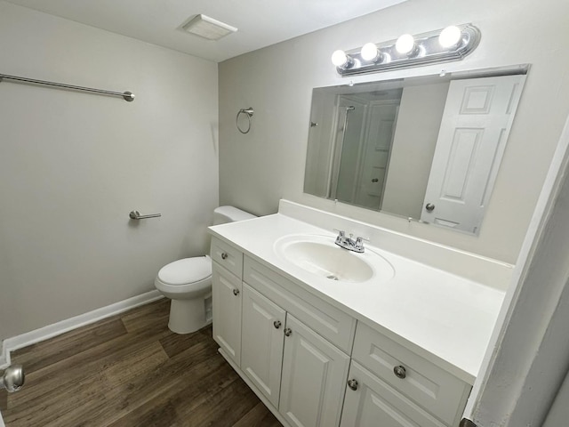 bathroom featuring hardwood / wood-style floors, vanity, and toilet