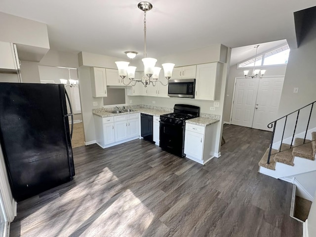 kitchen with black appliances, a notable chandelier, white cabinets, and sink