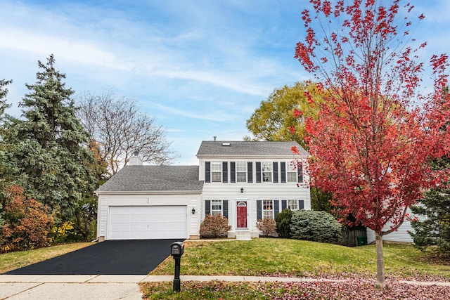 view of front facade featuring a front lawn and a garage