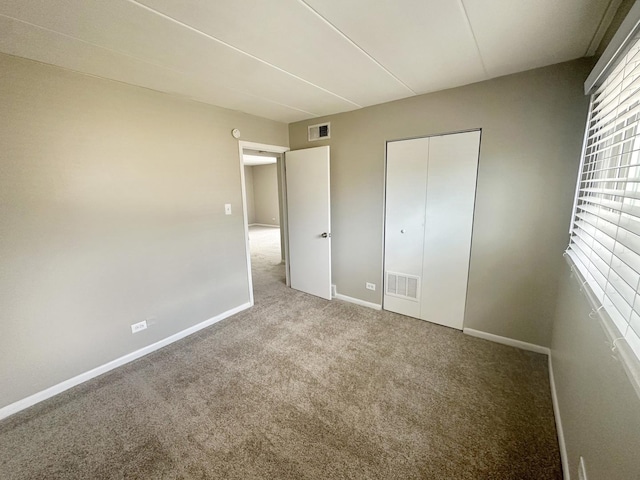 unfurnished bedroom with a closet and carpet