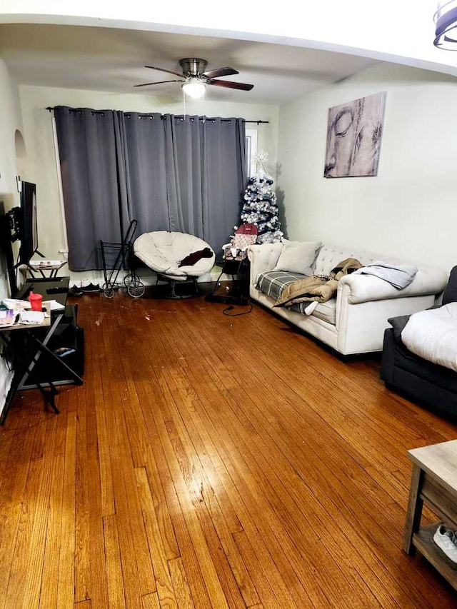 living room featuring ceiling fan and wood-type flooring