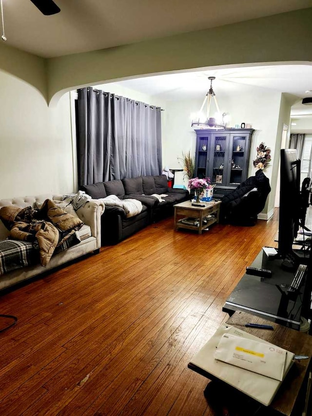 living room featuring a chandelier and wood-type flooring