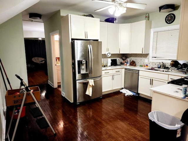 kitchen featuring backsplash, white cabinets, sink, appliances with stainless steel finishes, and dark hardwood / wood-style flooring