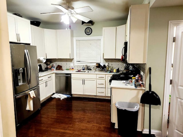 kitchen with backsplash, white cabinets, dark hardwood / wood-style floors, ceiling fan, and stainless steel appliances