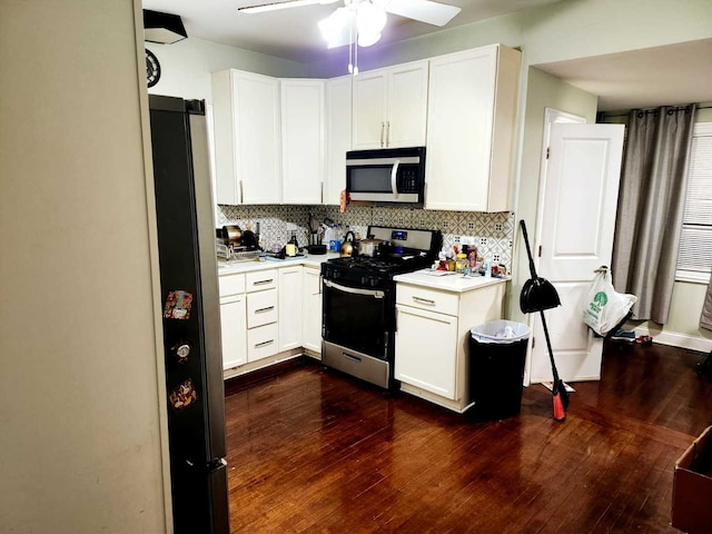 kitchen with decorative backsplash, stainless steel appliances, and white cabinetry