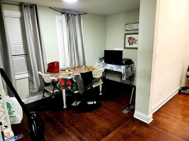 home office with dark wood-type flooring