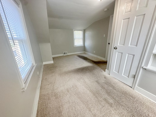 bonus room with carpet flooring and lofted ceiling