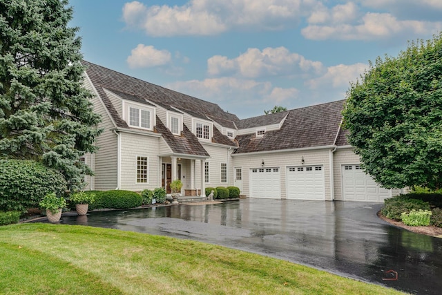 view of front of home featuring a front yard and a garage