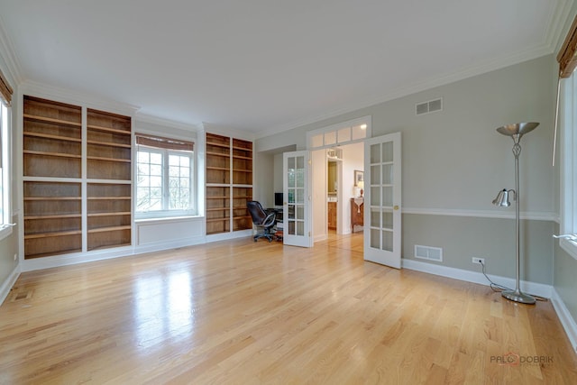 interior space featuring light hardwood / wood-style flooring, built in features, crown molding, and french doors