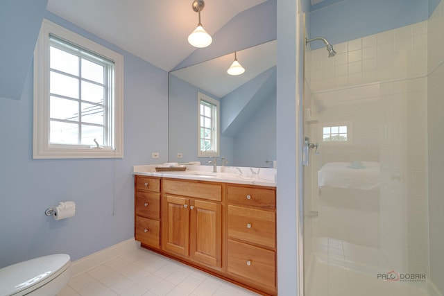 bathroom with vanity, lofted ceiling, tile patterned floors, toilet, and tiled shower