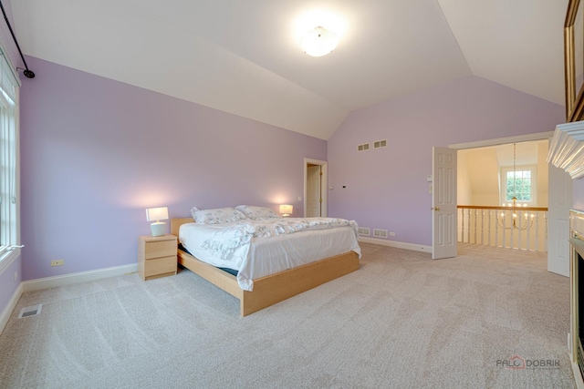 unfurnished bedroom featuring light carpet and vaulted ceiling