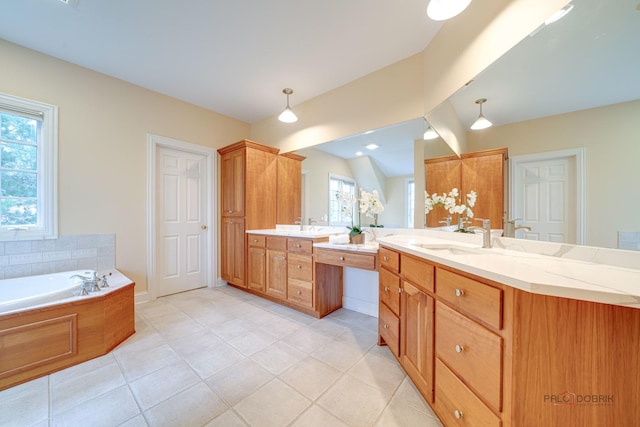 bathroom featuring tile patterned floors, a washtub, and vanity