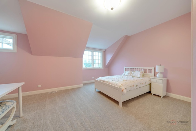 unfurnished bedroom featuring light carpet and lofted ceiling