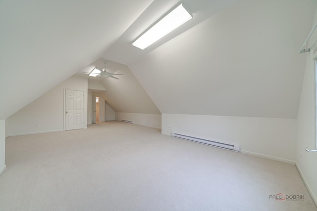 additional living space featuring light colored carpet, vaulted ceiling, baseboard heating, and ceiling fan