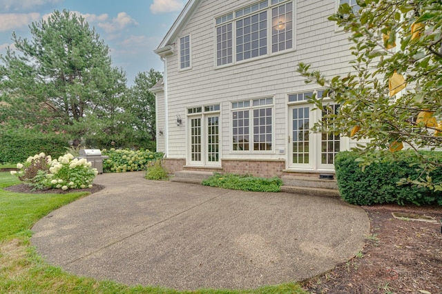 rear view of property featuring a patio area and french doors