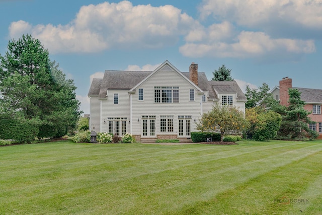 rear view of house with a yard and french doors