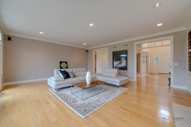 living room featuring light wood-type flooring and ornamental molding