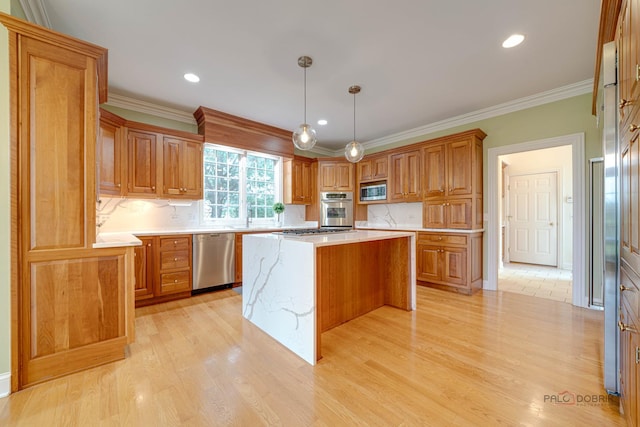 kitchen featuring pendant lighting, a center island, light wood-type flooring, appliances with stainless steel finishes, and tasteful backsplash