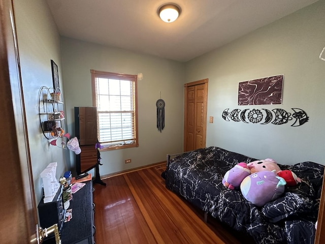 bedroom with dark hardwood / wood-style floors