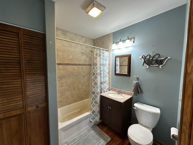 full bathroom featuring hardwood / wood-style floors, vanity, toilet, and shower / bath combo