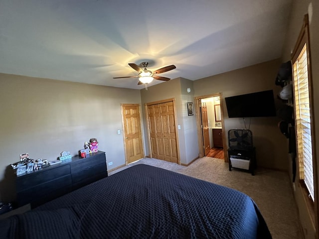 bedroom featuring ceiling fan, carpet floors, and ensuite bath