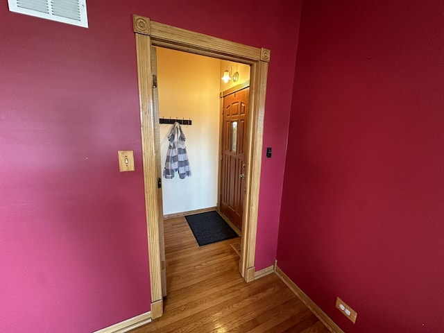 corridor featuring wood-type flooring