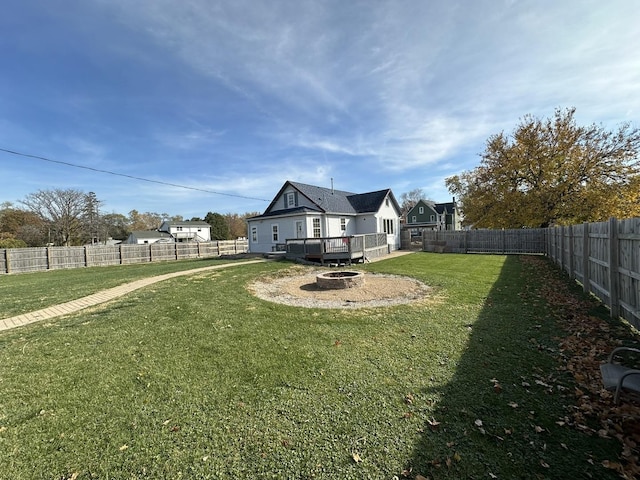 view of yard featuring a fire pit and a deck