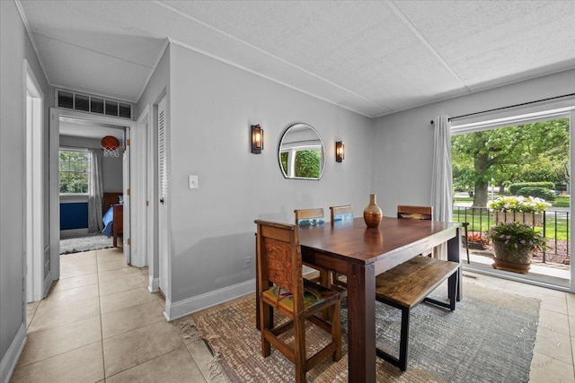 tiled dining area featuring a textured ceiling