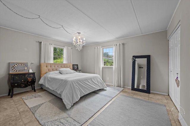 tiled bedroom with a closet and a chandelier