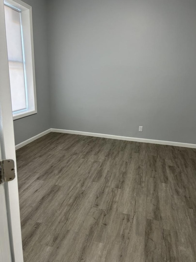 spare room with dark wood-type flooring