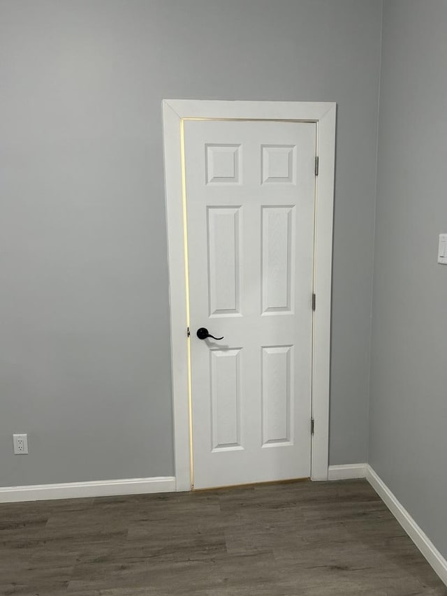 spare room featuring dark wood-type flooring