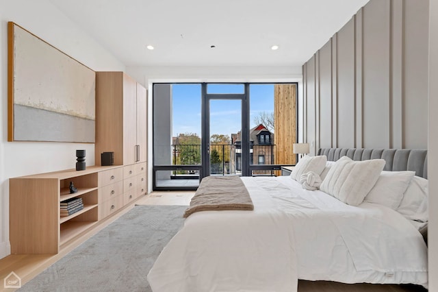 bedroom with access to outside and light hardwood / wood-style floors