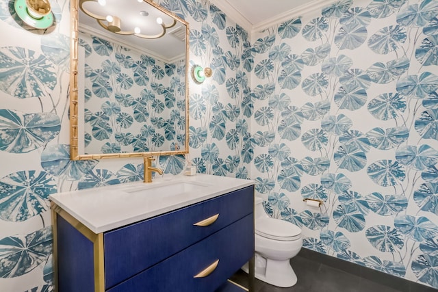 bathroom with tile patterned floors, crown molding, vanity, and toilet