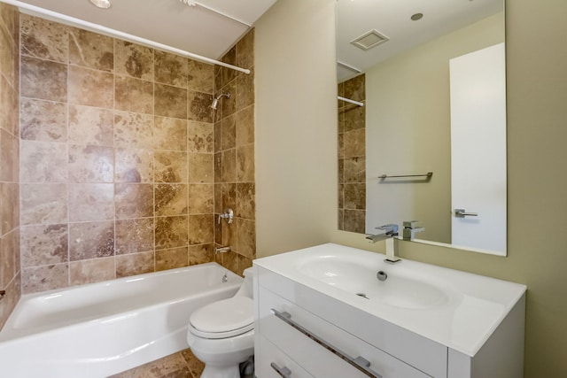 full bathroom featuring vanity, toilet, and tiled shower / bath combo