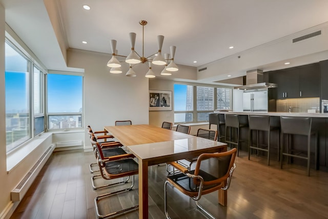 dining space featuring crown molding, a baseboard radiator, dark hardwood / wood-style floors, and a notable chandelier