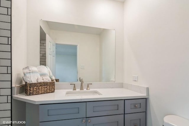 half bathroom with toilet and vanity