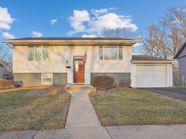 bi-level home with a front lawn and a garage