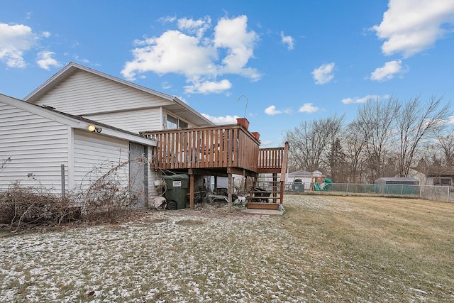 back of property featuring a deck and a yard