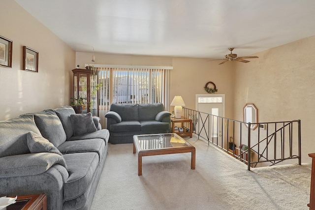 carpeted living room with ceiling fan