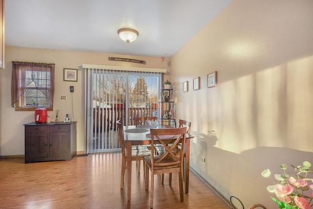 dining space with light hardwood / wood-style flooring