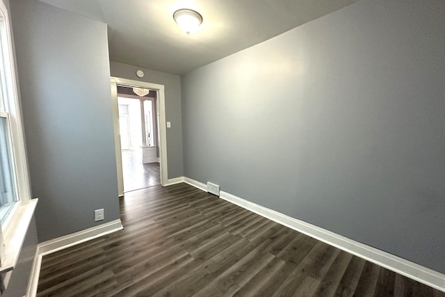 spare room with dark hardwood / wood-style flooring